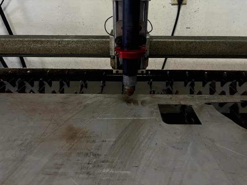 Plasma cutting torch in operation on mild steel plate