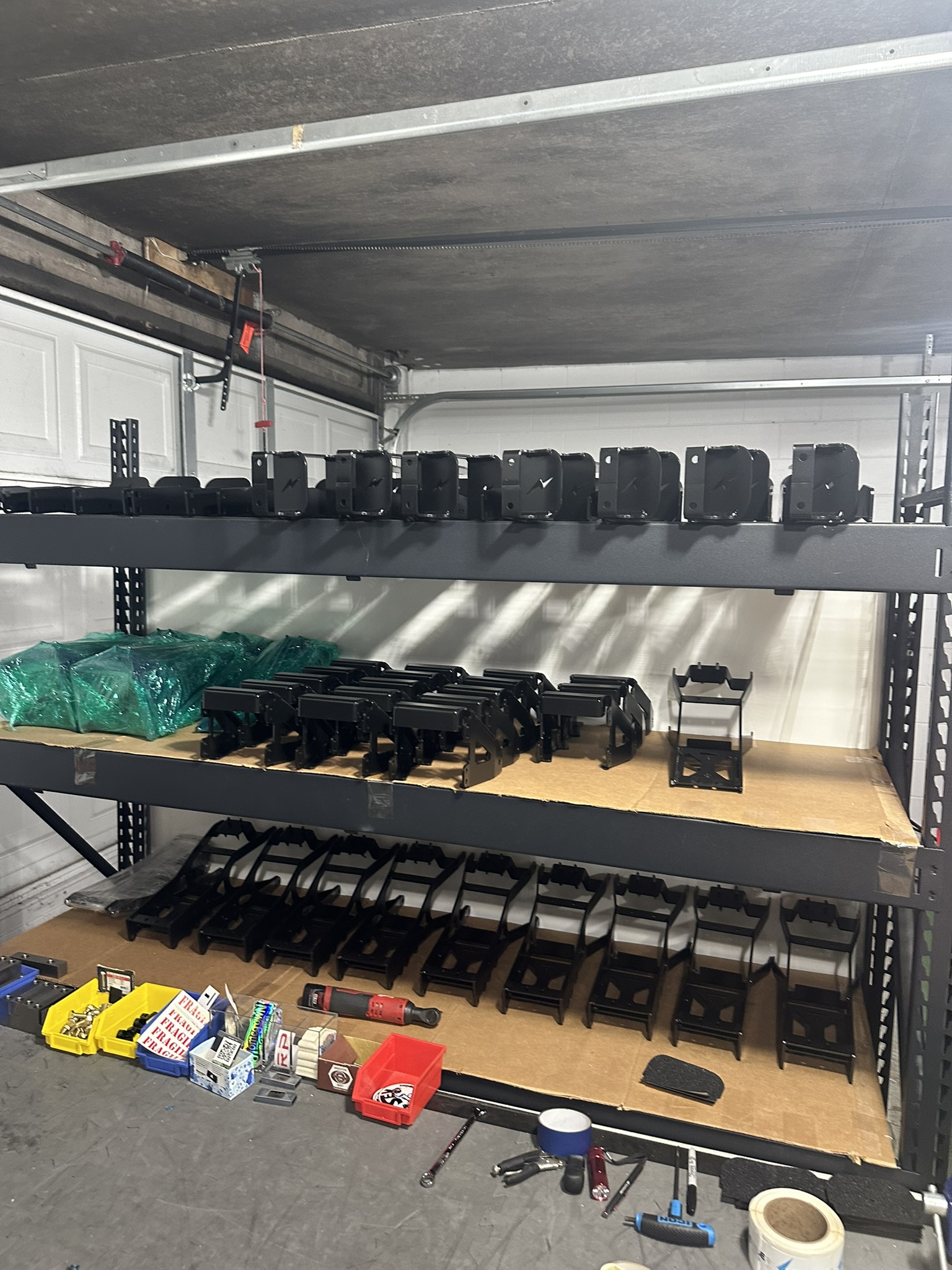 Shelves full of finished fabricated brackets, 100 parts completed overnight
