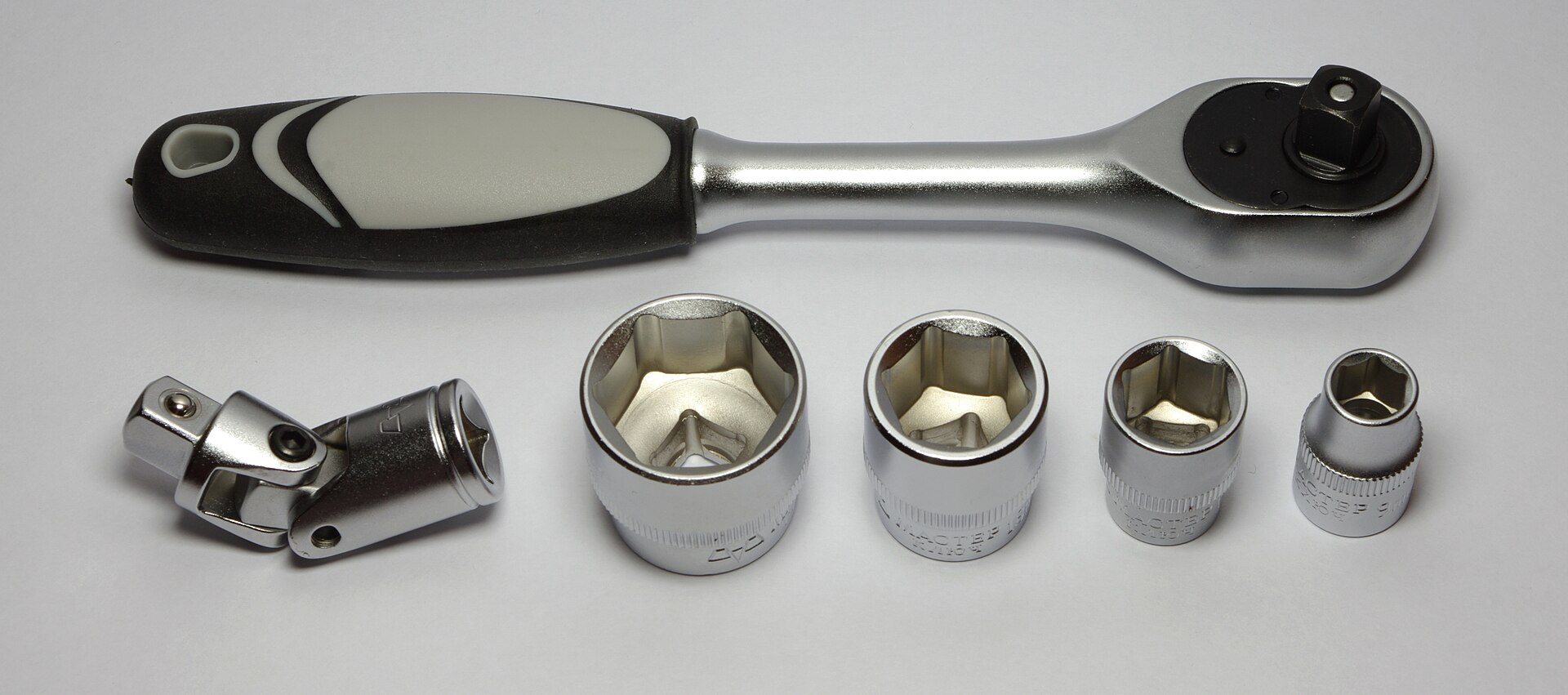 A ratchet handle with a spread of interchangeable sockets